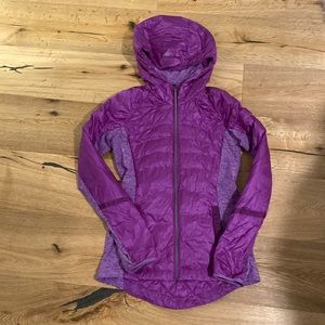 Similar to the another mile jacket. Part down and fitted in the waist.